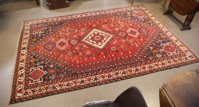 a rug on the floor in a room with a chair