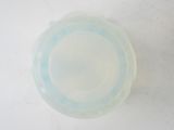 a plastic bowl with a lid sitting on a table