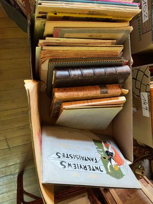 une pile de livres posée sur une chaise dans une pièce