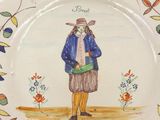 a plate with a picture of a woman wearing a hat and holding a bag