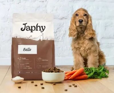 a dog that is sitting next to a bag of dog food