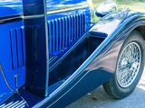 a blue car parked on the side of the road