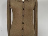 brown cardigan sweater on a mannequin stand with a blue chair