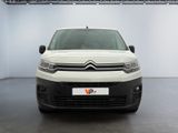 the white van is parked in a large white room