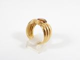 a close up of a gold ring with a brown stone