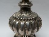 an image of a silver vase sitting on top of a white table