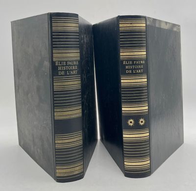 two black books with gold trims on them sitting side by side