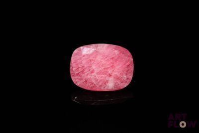 a picture of a pink stone on a black surface