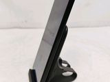 a cell phone that is on a stand on the table