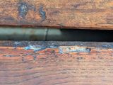 a close up of a wooden bench with peeling paint on it