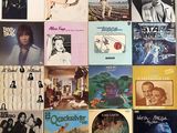 many different album covers on the wall of this room