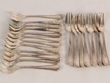a lot of forks and spoons sitting on a table