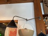 a lamp that is on the wall next to a mirror
