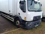 two trucks that are parked next to each other on the side of the road