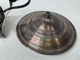 a silver tea pot and a silver tea kettle on a table