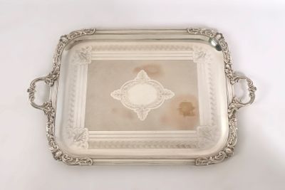 an antique silver tray with a picture of a woman on it