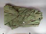 a bag of clothing on a table next to a clock