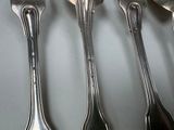 four spoons that are sitting on a table