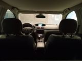 two seats in the back of a car with the sun shining through the window
