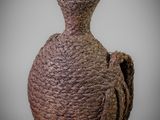 a brown vase that has a rope wrapped handle on it
