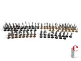 a group of small metal figurines sitting on top of a white surface
