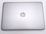 hp laptop computer sitting on a white surface with a logo on the screen