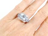 a woman ' s hand with a diamond ring on it