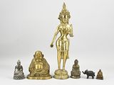 a group of four bronze figurines of buddhas and cats