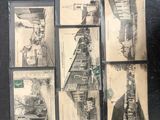 a black and white photo of a bunch of old postcards