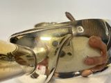 a person that is holding a silver object in their hand
