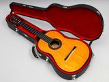 a guitar inside of a case on a white surface