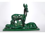 an image of a statue of a deer and a dog on a green base