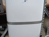 an image of a white refrigerator in a warehouse