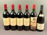several bottles of wine are lined up on a table