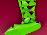 neon green boots with spikes and rivets on a red background