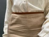 a close up of a woman wearing a skirt and a white shirt