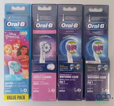 four toothbrushes are lined up in a row on a table