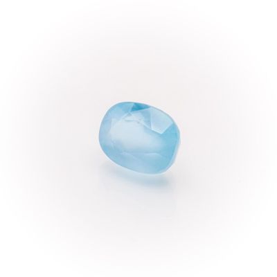 a close up of a blue topazte stone on a white surface
