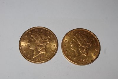 deux pièces d'or posées côte à côte sur une surface blanche
