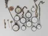 many different types of pocket watches displayed on the wall