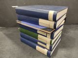 several books stacked on top of each other on a table