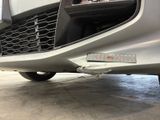 a close up of a car ' s front bumper with a number plate on it
