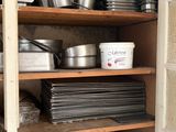 many pots and pans on the shelves in the kitchen