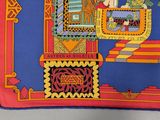 an image of a blue and red scarf with a picture of a man on a throne