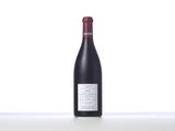 a bottle of red wine sitting on top of a table