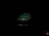 a green oplite in the dark