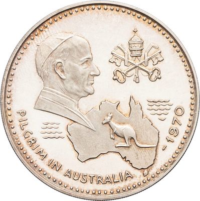 an australian one dollar coin with a picture of a man holding a dog