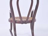 a wooden rocking chair with a wicker seat