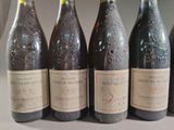 six bottles of wine are lined up in a row on a table