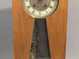 a wooden clock that is sitting on a table